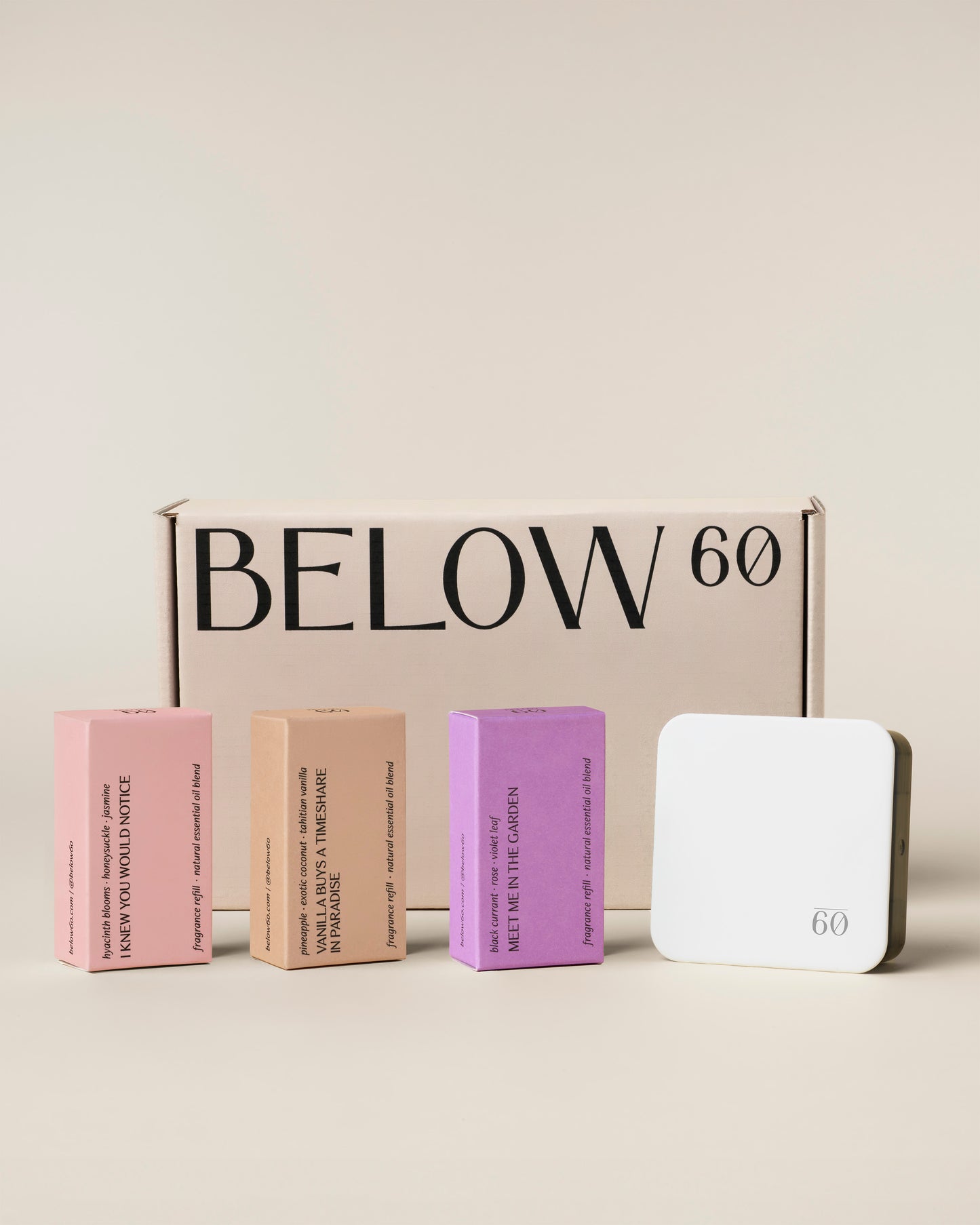 The Seasonal Diffuser Starter Kit — Spring, featuring the Below 60 Plug-In Home Diffuser and three fragrance refills: I Knew You Would Notice, Vanilla Buys a Timeshare in Paradise, and Meet Me in the Garden, displayed in front of a Below 60 gift box.