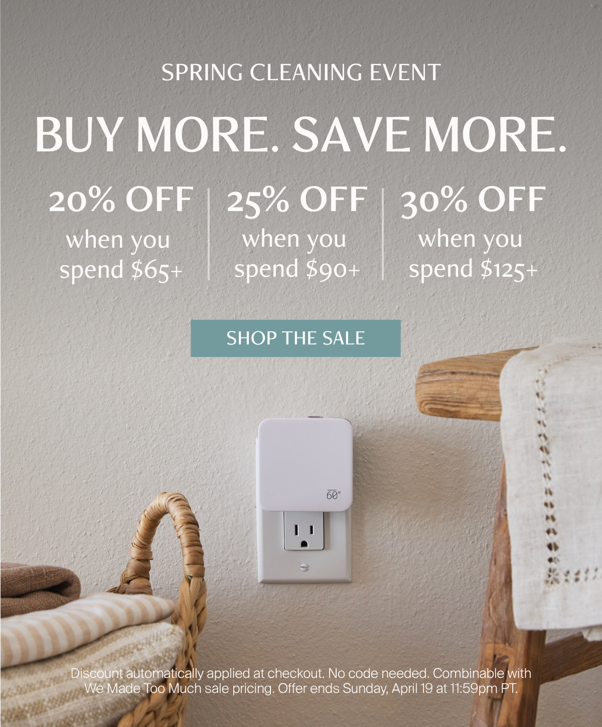 The Below 60 Plug-In Home Fragrance Diffuser plugged into a wall outlet styled with a wicker laundry basket and folded linens. Text overlay reads: Spring Cleaning Event — Buy More. Save More. — 20% off when you spend $65+, 25% off when you spend $90+, 30% off when you spend $125+.
